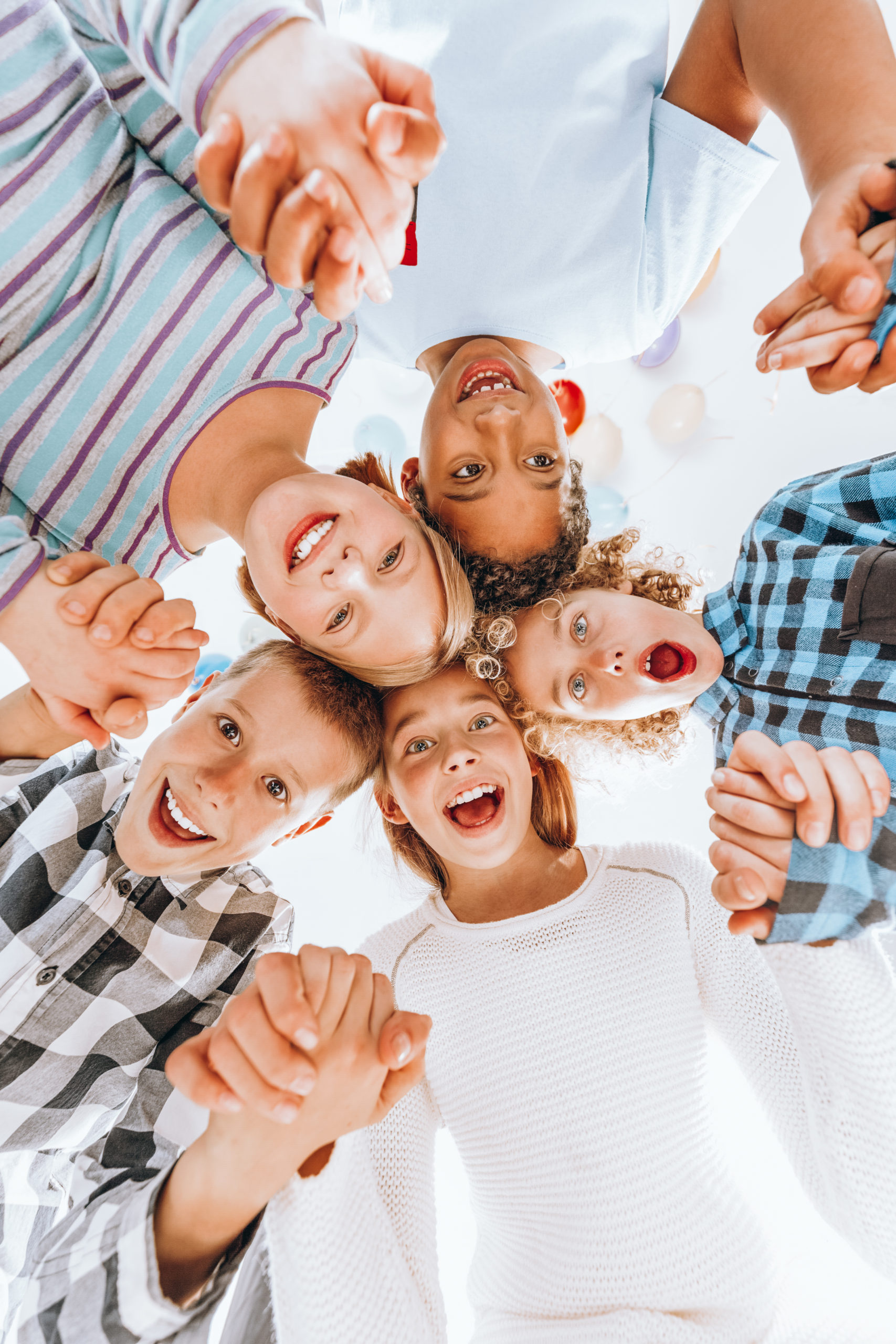 Happy children standing in the circle and holding hands